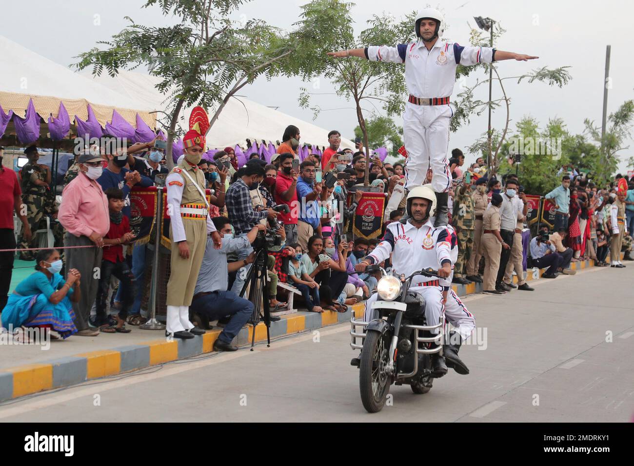 Indian Border Security Force (BSF) soldiers perform stunts on a bike ...