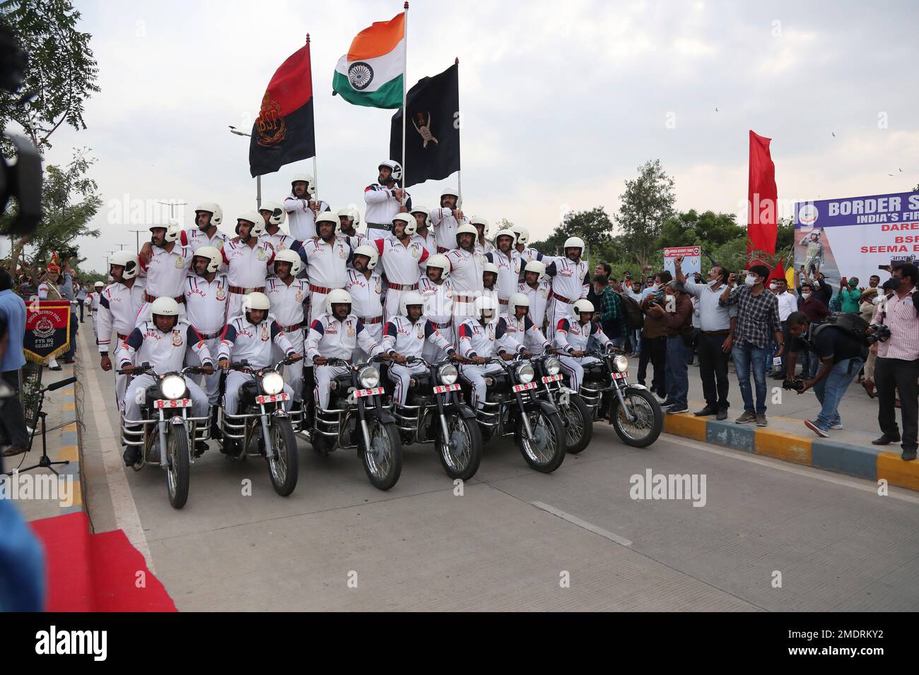 Indian Border Security Force (BSF) soldiers perform a stunt on a bike ...