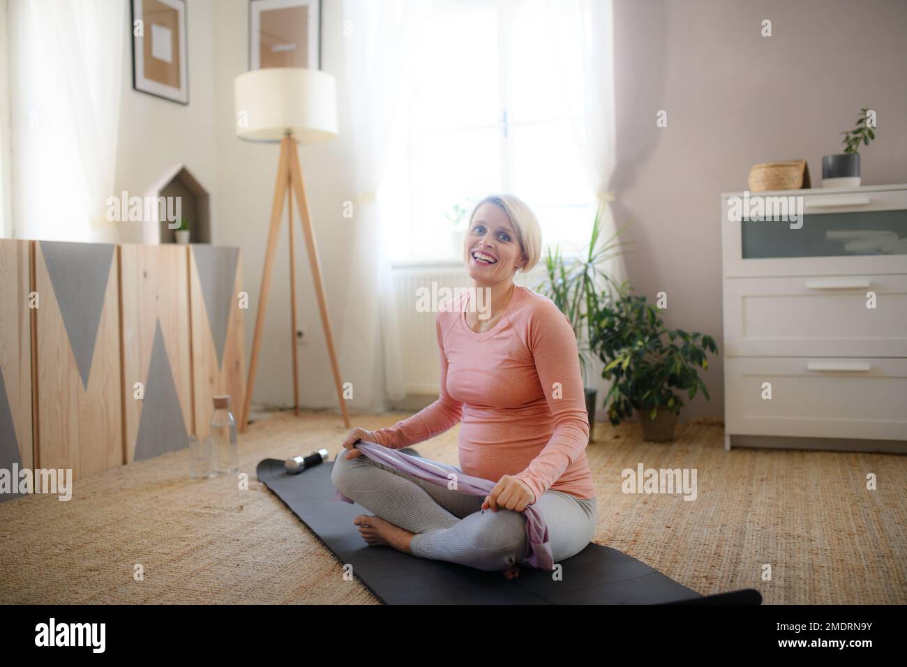 Pregnant woman doing exercises in her apartment Stock Photo - Alamy