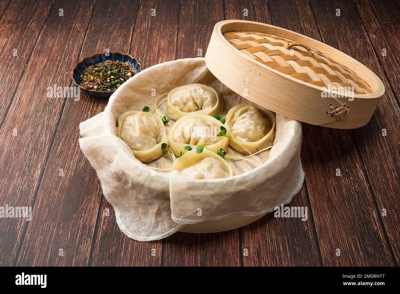Delicious homemade Korean kimchi dumplings in a bamboo steamer. Stock Photo