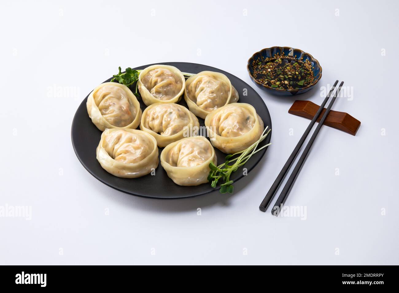 Delicious homemade Korean kimchi dumplings and sauce, white background Stock Photo