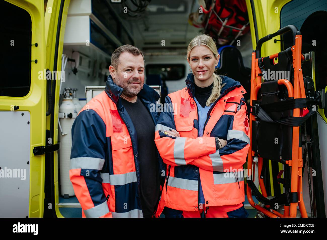 Portrait of rescuers in front of ambulance car. Stock Photo