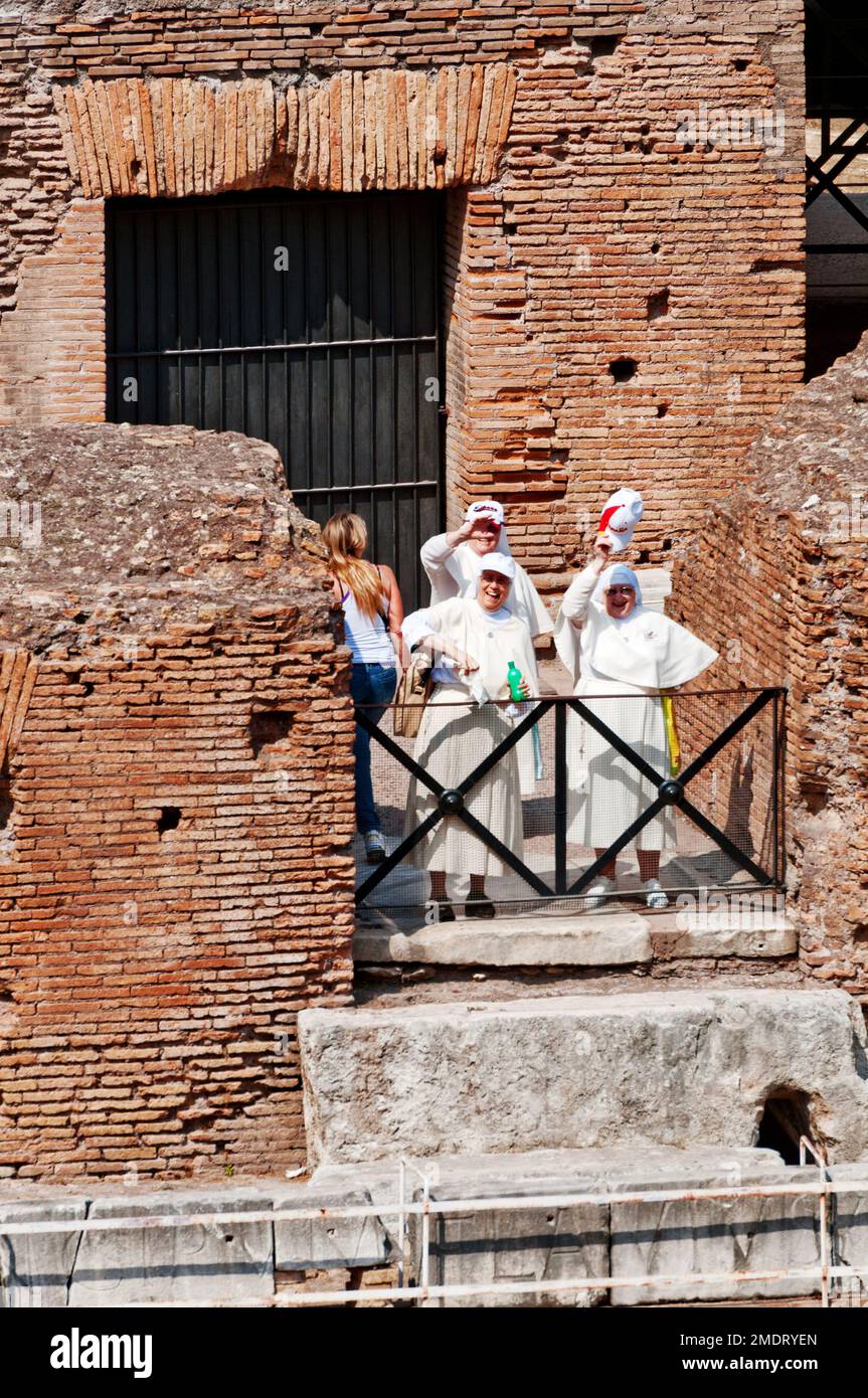 Nuns waving inside the Colosseum, Rome, Italy Stock Photo