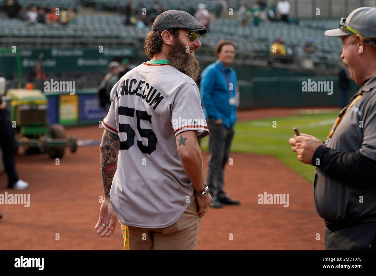 Former Oakland Athletics pitcher Dallas Braden wears a jersey of former San  Francisco Giants pitcher Tim Lincecum before a baseball game between the  Athletics and the Giants in Oakland, Calif., Friday, Aug.