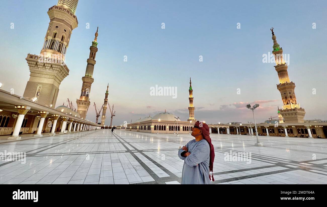 A traveler visiting the Al-Masjid an-Nabawi or the Prophet's Mosque in the city of Medina in the Al Madinah Province of Saudi Arabia Stock Photo