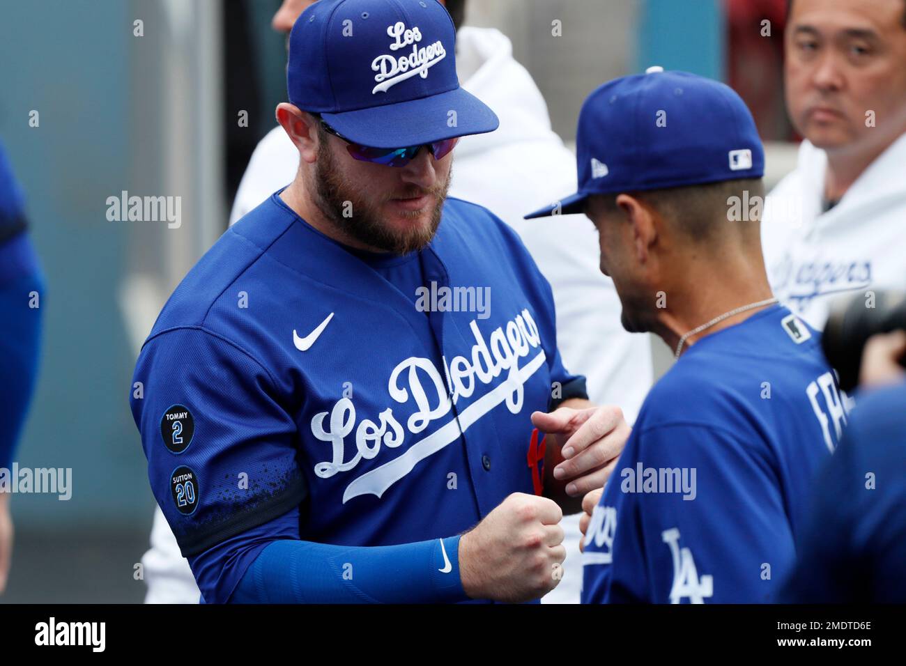 Los Angeles Dodgers' Max Muncy, left, greets Dino Ebel in the