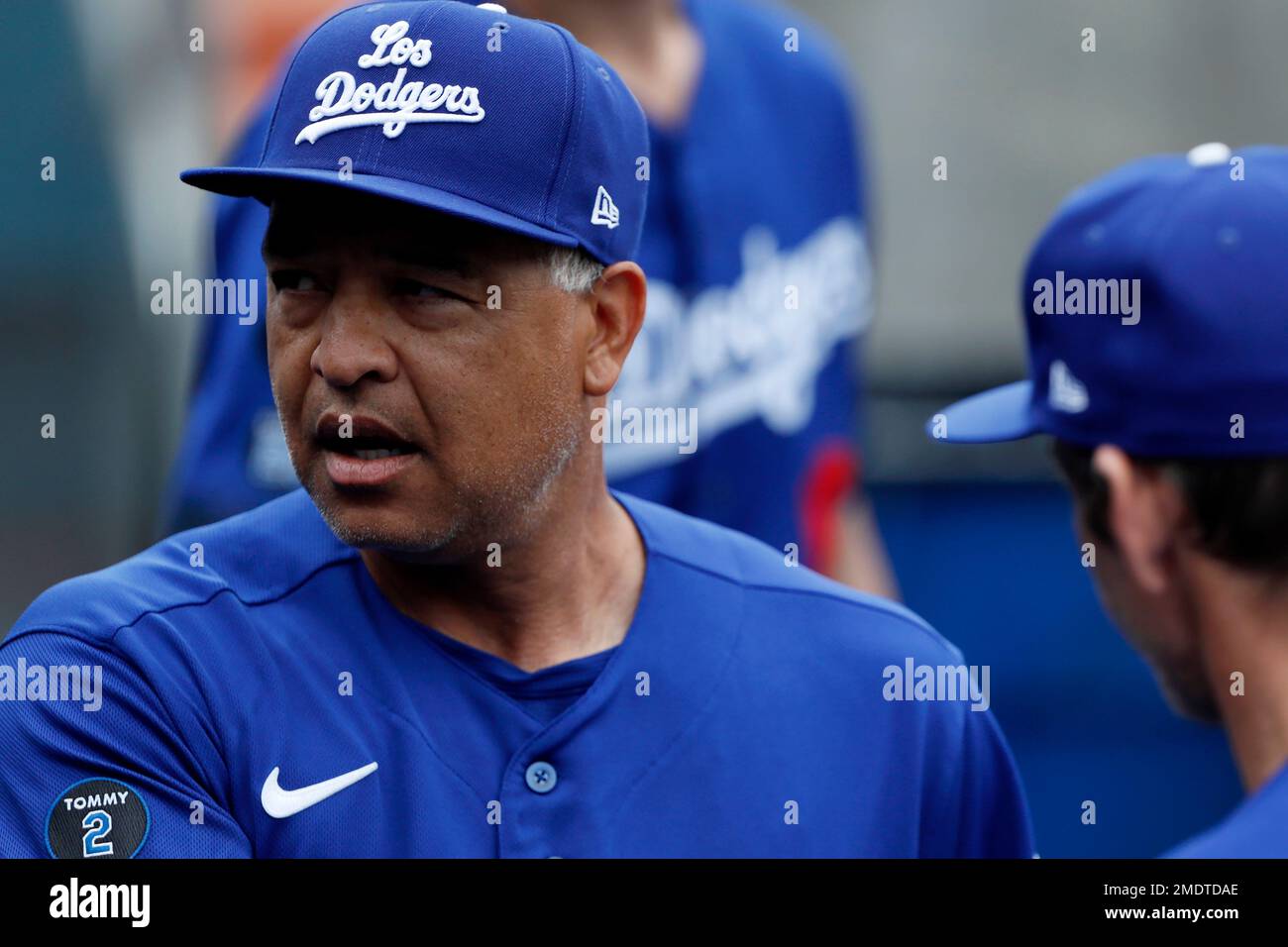 Los Angeles Dodgers' Dave Roberts walks in the dugout wearing a new Los Dodgers  uniform before a baseball game against the New York Mets in Los Angeles,  Saturday, Aug. 21, 2021. (AP