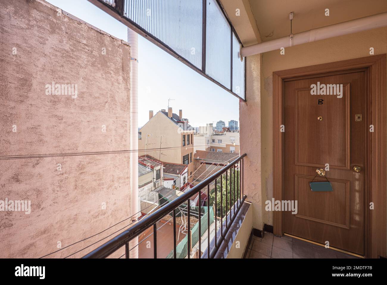 Entrance of a house with a corridor with a viewpoint with a black metal ...