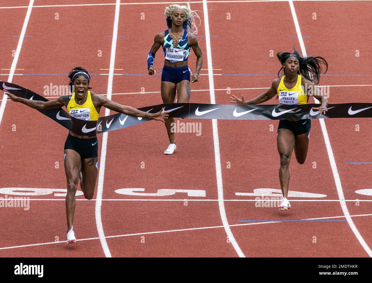 Jamaica's Elaine ThompsonHerah, left, wins the 100 meters, as American