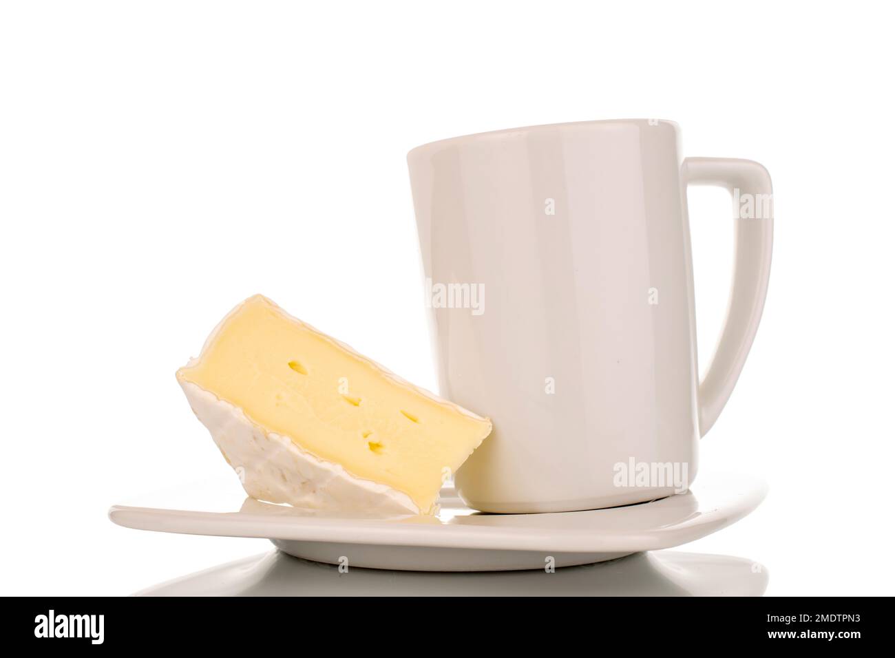 One piece of fragrant Brie cheese on a white ceramic saucer with a