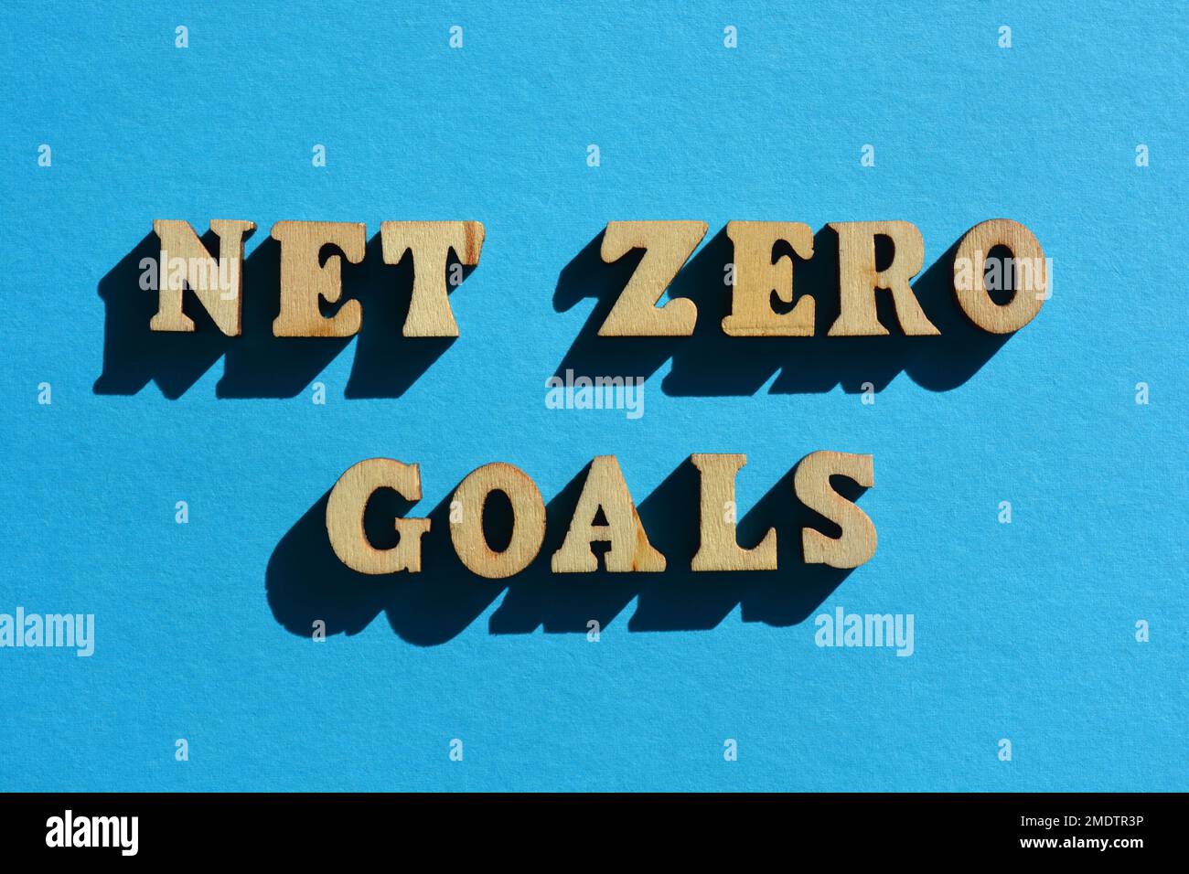 Net Zero Goals, words in wooden alphabet letters isolated on blue background Stock Photo