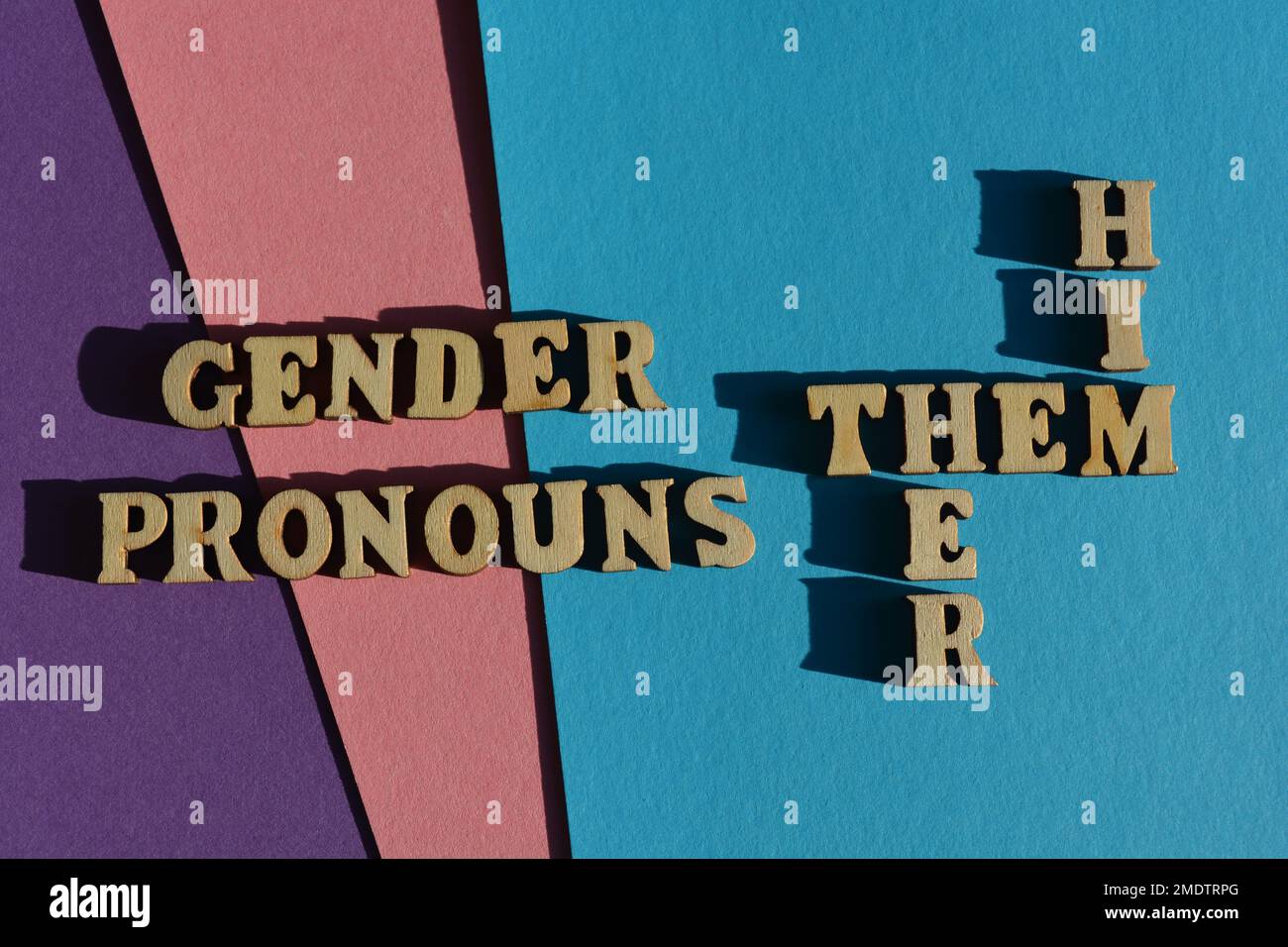 Gender Pronouns, Him, Her, Them, words and crossword in wooden alphabet letters isolated on