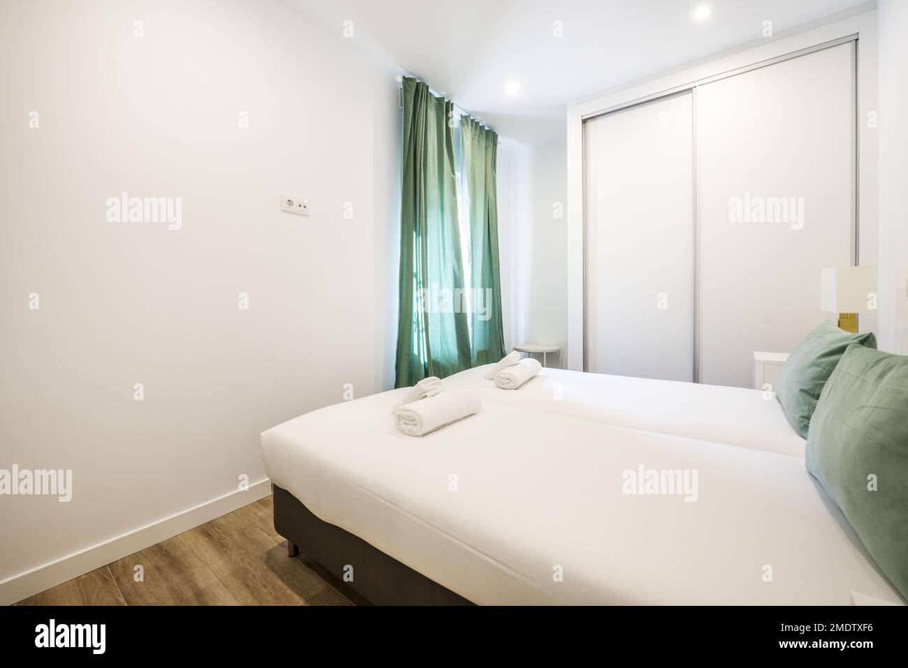 Bedroom with a twosection builtin wardrobe with white sliding doors