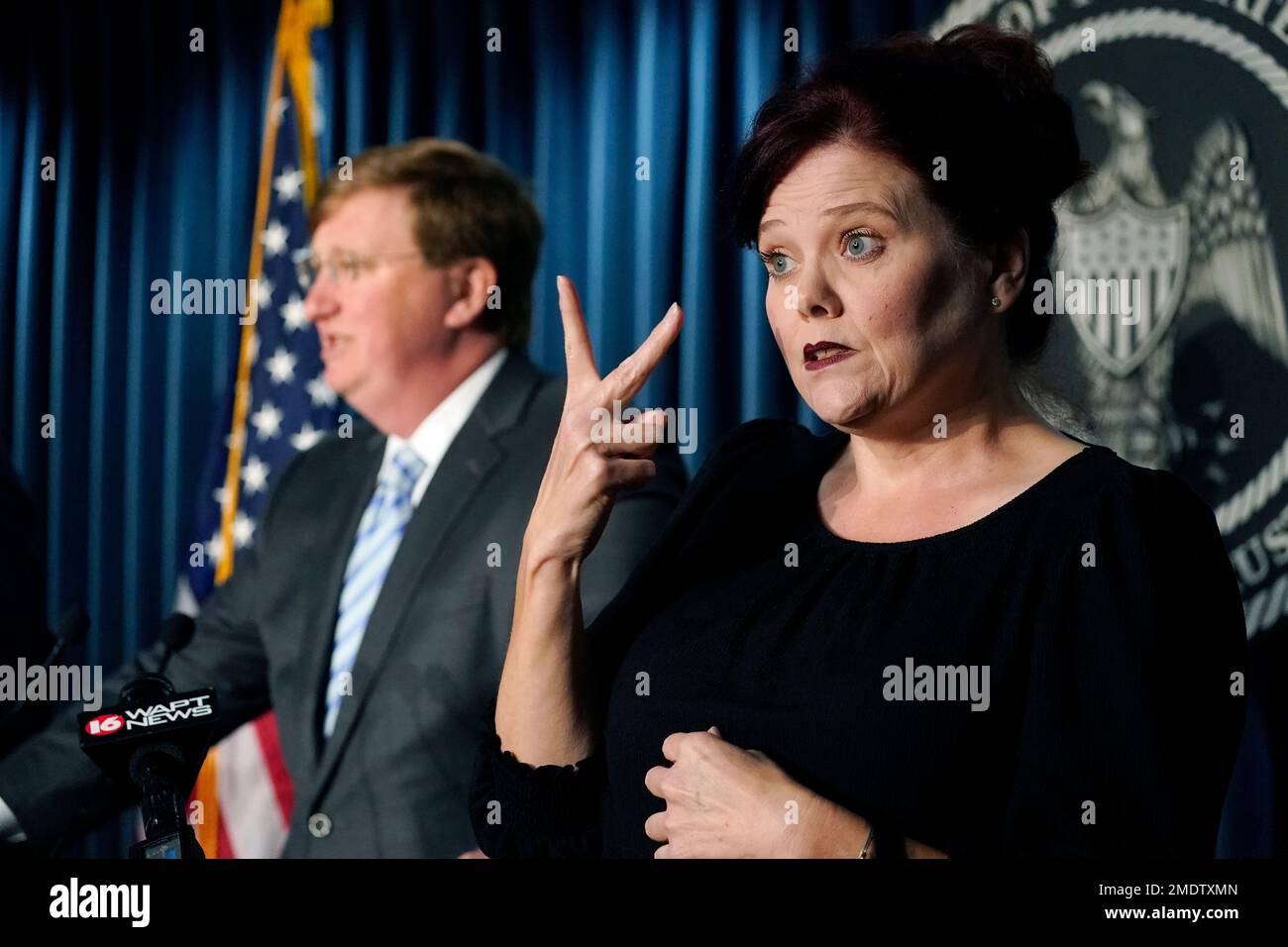 Sign language interpreter Amy Ainsworth signs as Gov. Tate Reeves