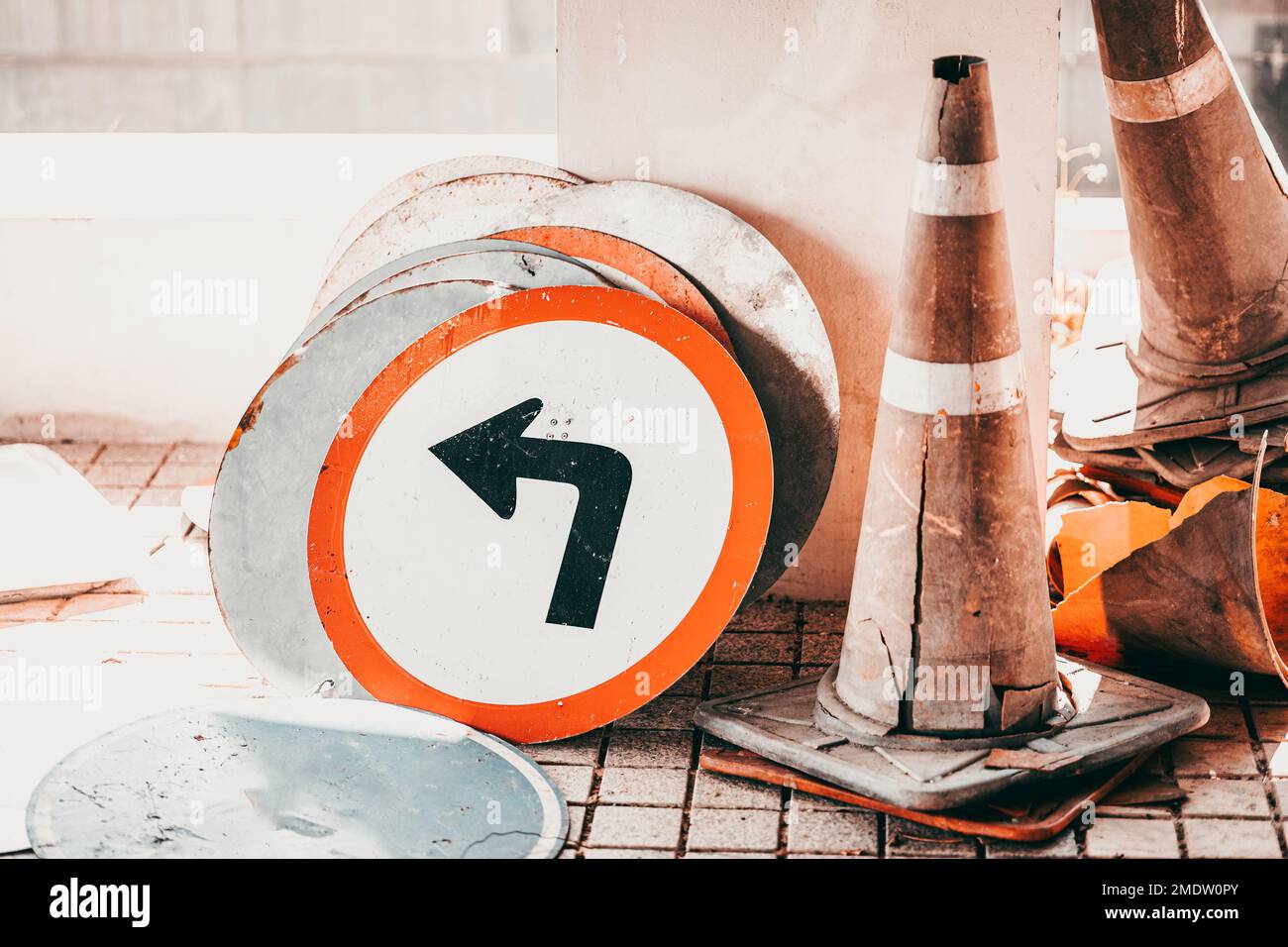 old unused dirty broken road traffic sign banner and traffic cone waste grunge Stock Photo