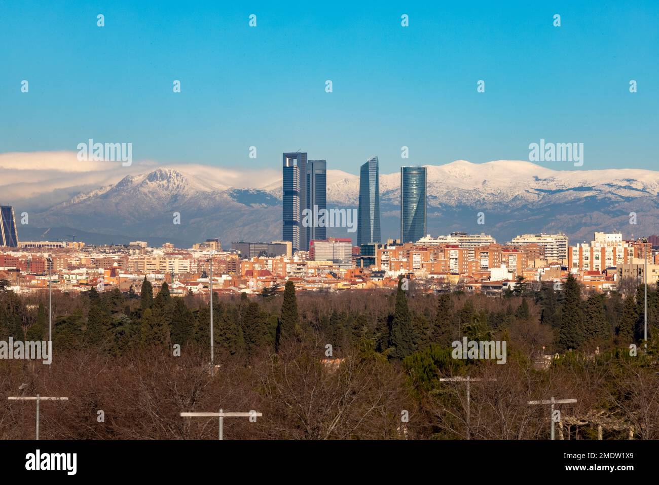 Madrid. Skyline of the city of Madrid with the Sierra de Guadarrama. White mountain full of white snow. City concept. Winter concept. Photography. Stock Photo