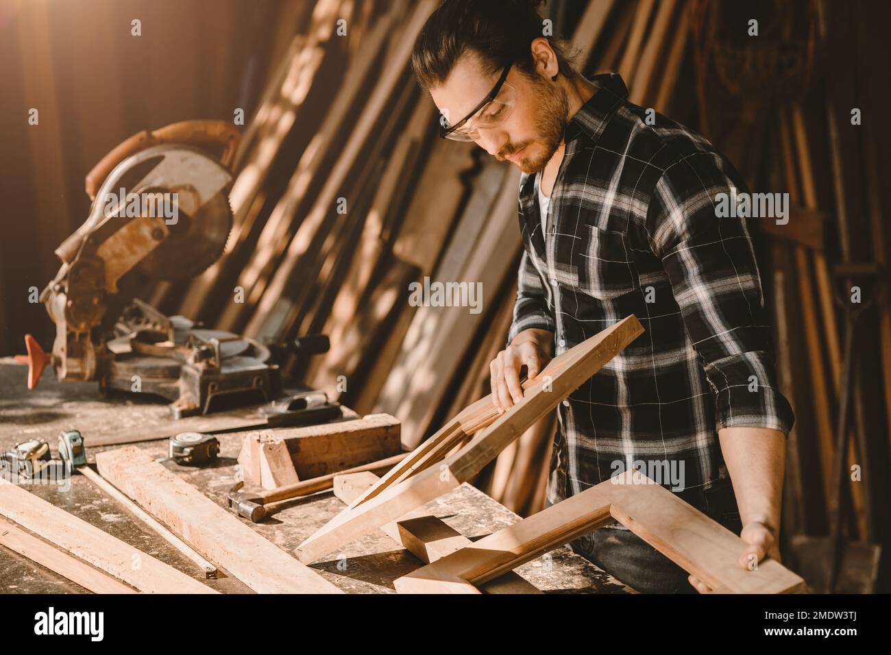 male wood furniture joiner work in DIY wooden workshop real authentic people worker Stock Photo