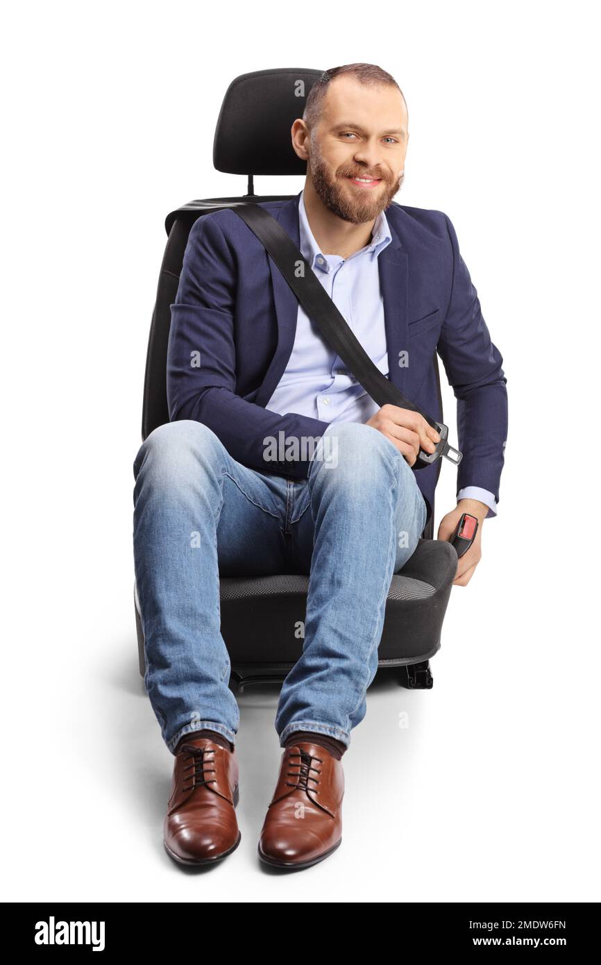 Male passenger putting on a seat belt in a car seat and smiling