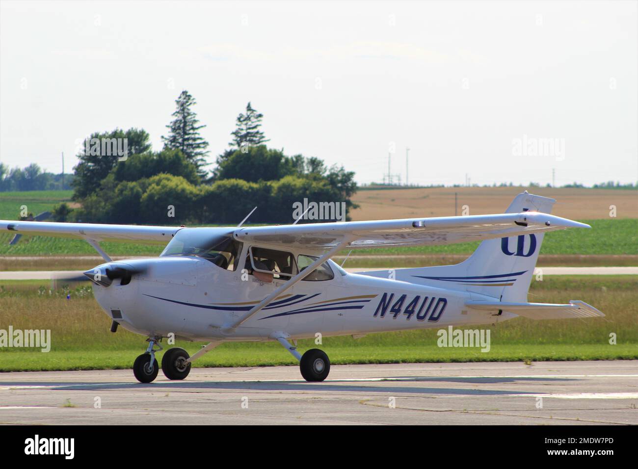 Cessna 172 operated by the University of Dubuque taxing to parking after a training flight. Stock Photo