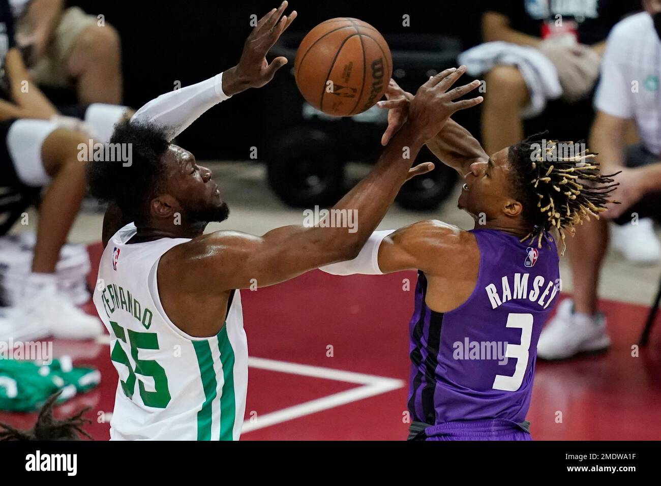 Boston Celtics' Bruno Fernando, left, fouls Sacramento Kings' Jahmi'us  Ramsey during the first half of the NBA summer league championship  basketball game Tuesday, Aug. 17, 2021, in Las Vegas. (AP Photo/John Locher