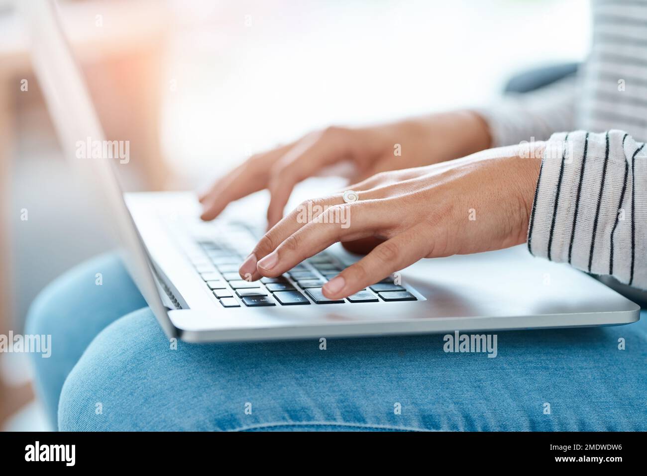 When blogging is a passion...an unrecognizable young woman using her laptop at home. Stock Photo