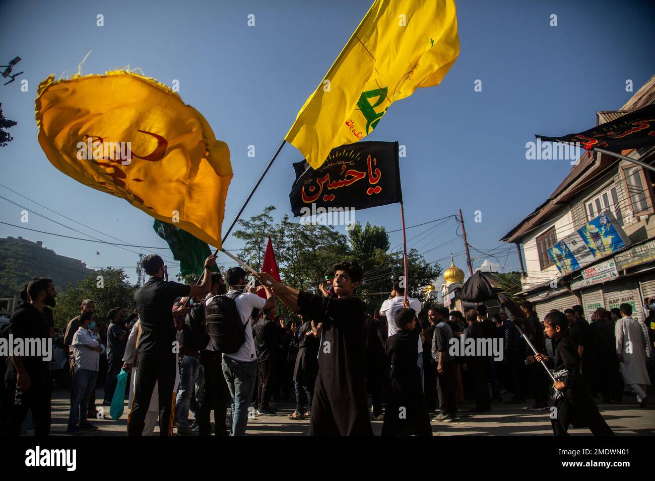 Kashmiri Shiite Muslims wave flags as they participate in a Muharram ...
