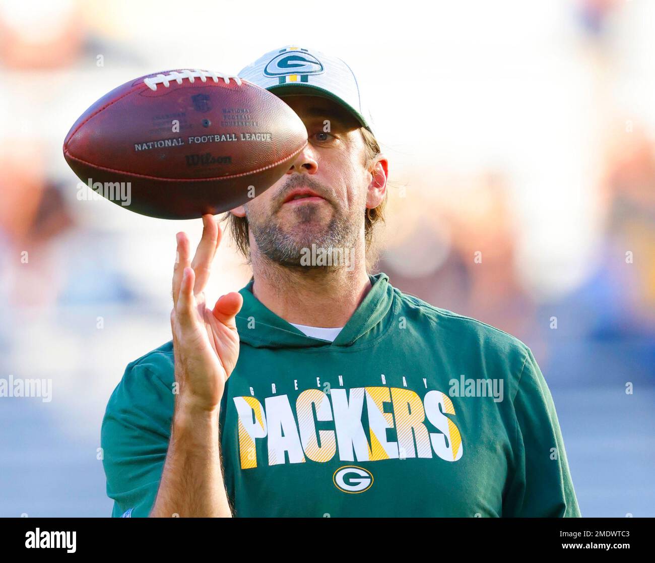 Green Bay Packers' quarterback Aaron Rodgers spins the ball on his fingers before the team's