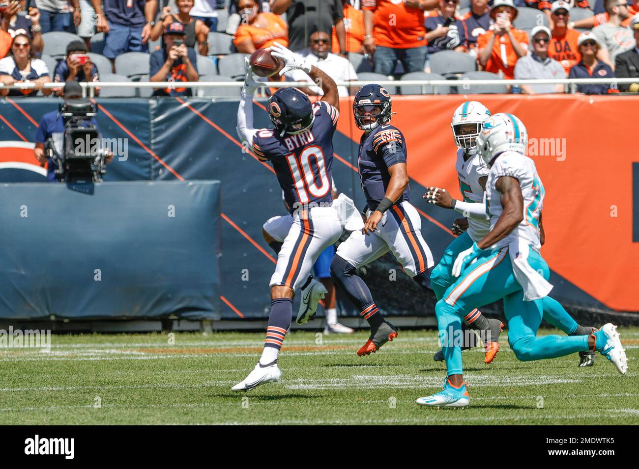 Chicago Bears wide receiver Damiere Byrd (10) catches a pass from  quarterback Justin Fields (1) during the first half of a preseason NFL  football game against the Miami Dolphins, Saturday, Aug. 14