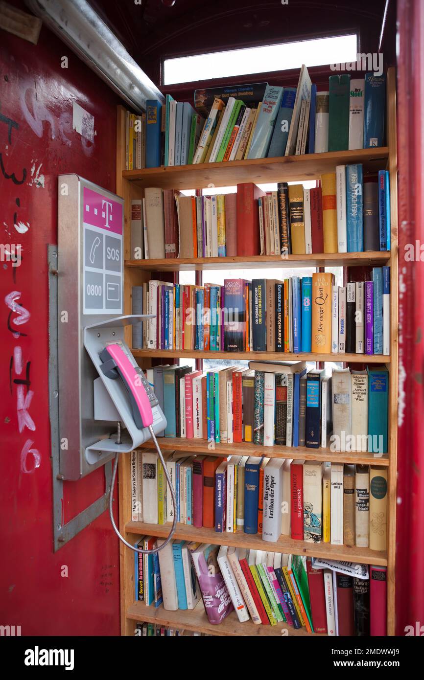 British red telephone box used as a book exchange, Hachenburg, Westerwaldkreis in Rhineland-Palatinate, Germany Stock Photo