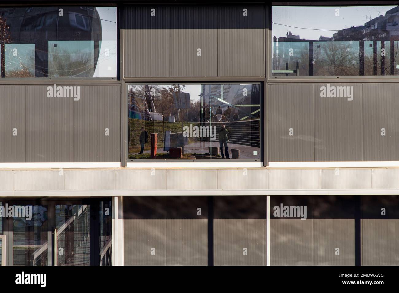 Reflections on the glass surfaces of a building facade Stock Photo