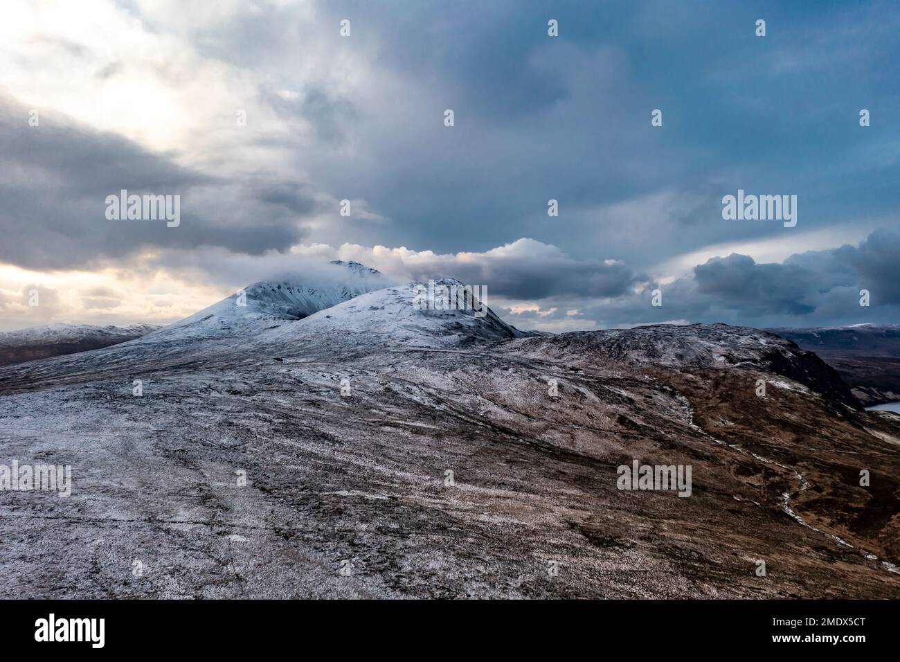 Aerial view of the snow covered Mount Errigal with dramatic clouds, the highest mountain in Donegal - Ireland Stock Photo