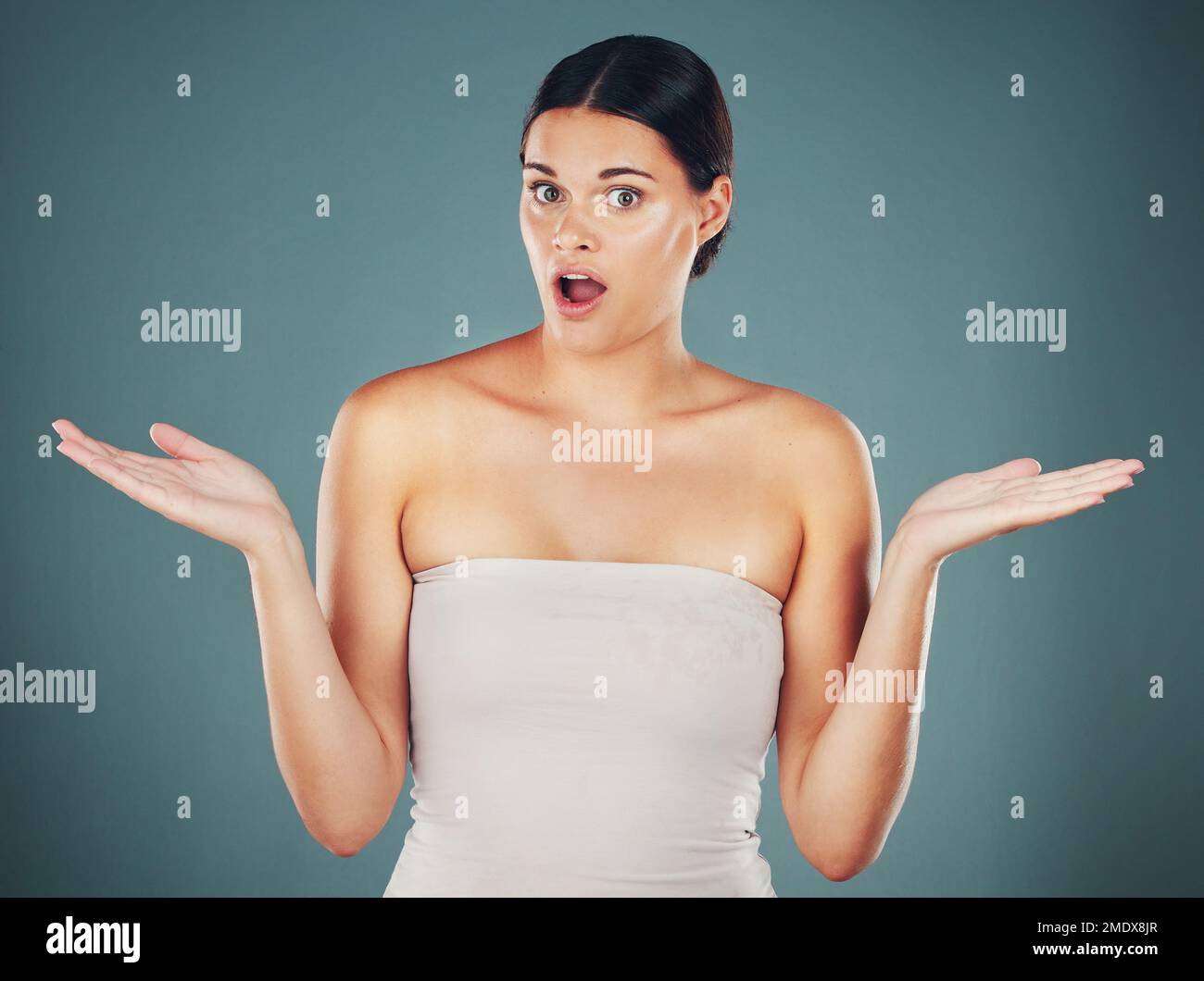 Woman, shocked face portrait and hands for surprise, announcement or excited isolated in studio background. Young female, scared facial expression and Stock Photo