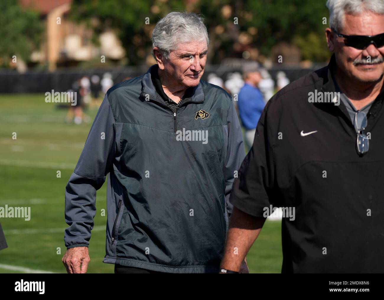 Retired Colorado head football coach Bill McCartney looks on as players