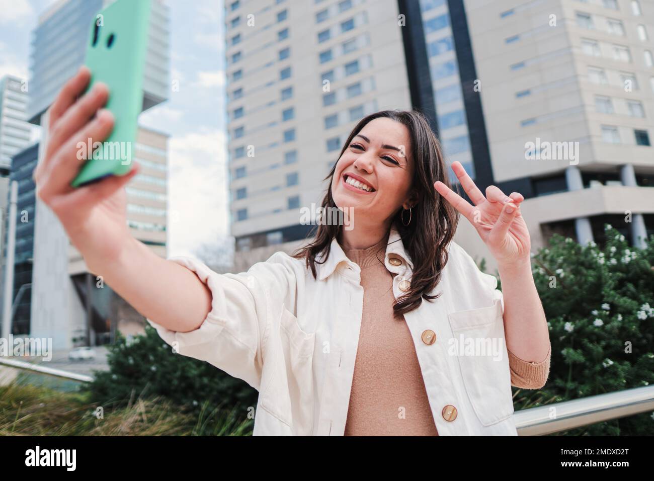 Close up portrait of one young woman smiling taking a selfie portrait ...