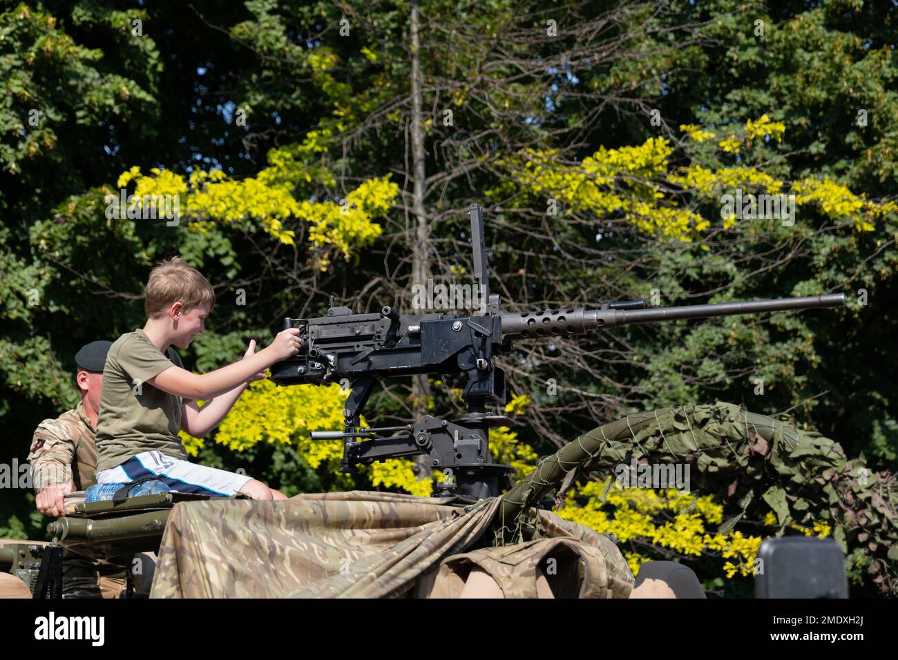 Warsaw, Poland - August 14, 2022 - Boy with 12.7mm heavy machine gun on Jackal armoured reconnaissance vehicle during Polish Army Day (Armed Forces Da Stock Photo