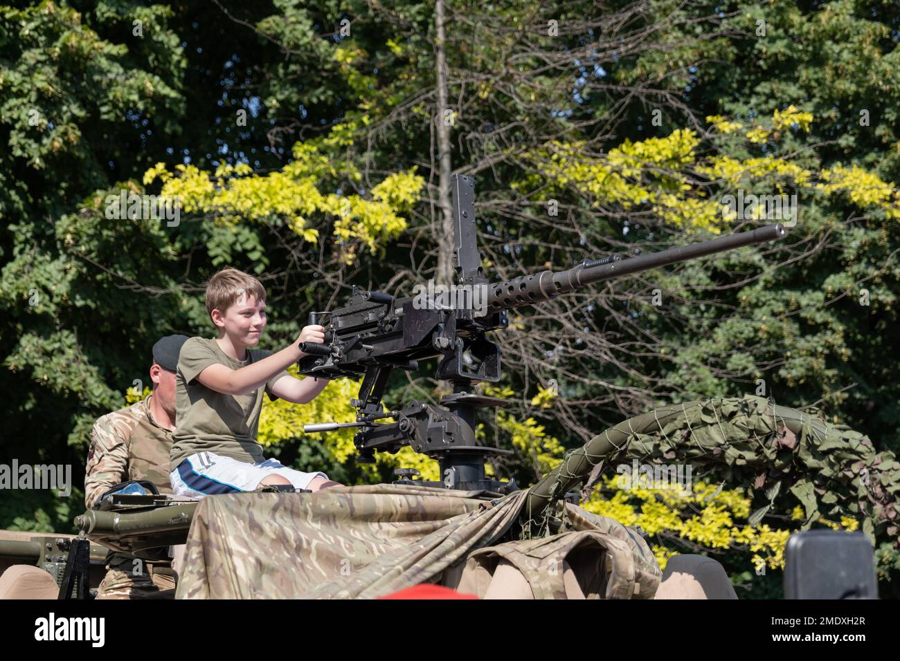 Warsaw, Poland - August 14, 2022 - Boy with 12.7mm heavy machine gun on Jackal armoured reconnaissance vehicle during Polish Army Day (Armed Forces Da Stock Photo
