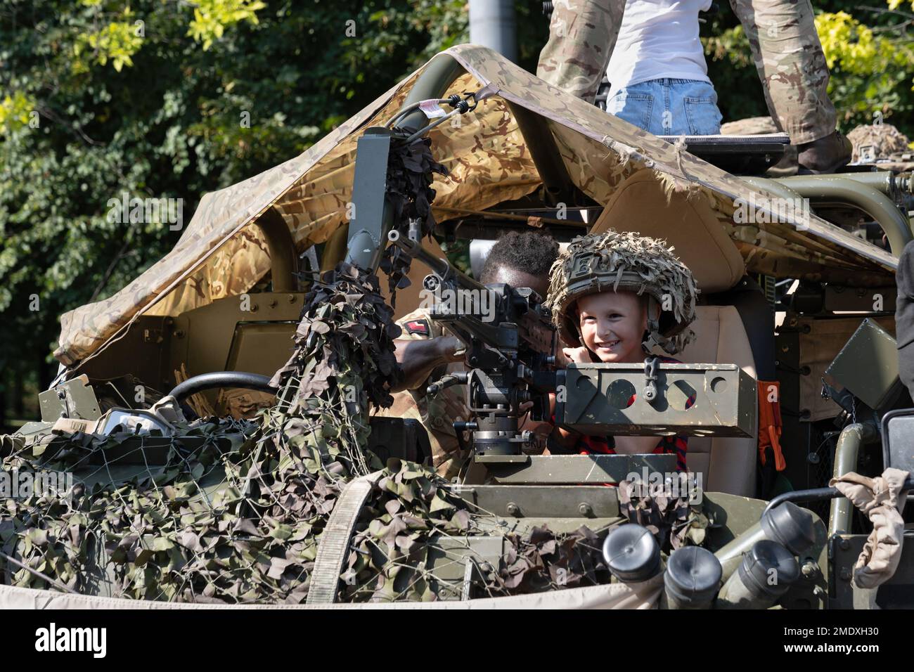 Warsaw, Poland - August 14, 2022 - Boy with heavy machine gun on Jackal armoured reconnaissance vehicle during Polish Army Day (Armed Forces Day) nati Stock Photo