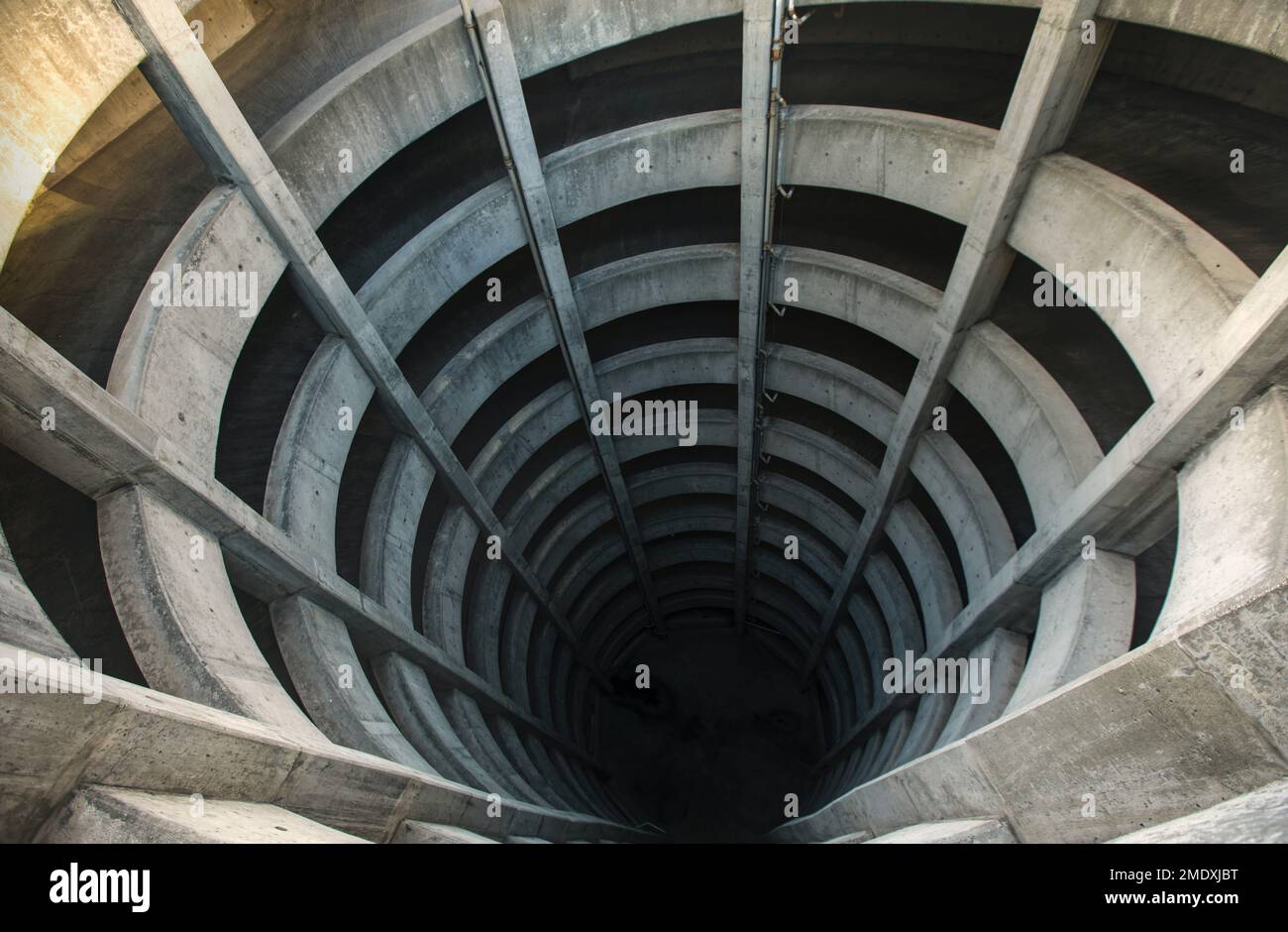 An aerial view of a spiral tunnel extending into an illusion of a deep