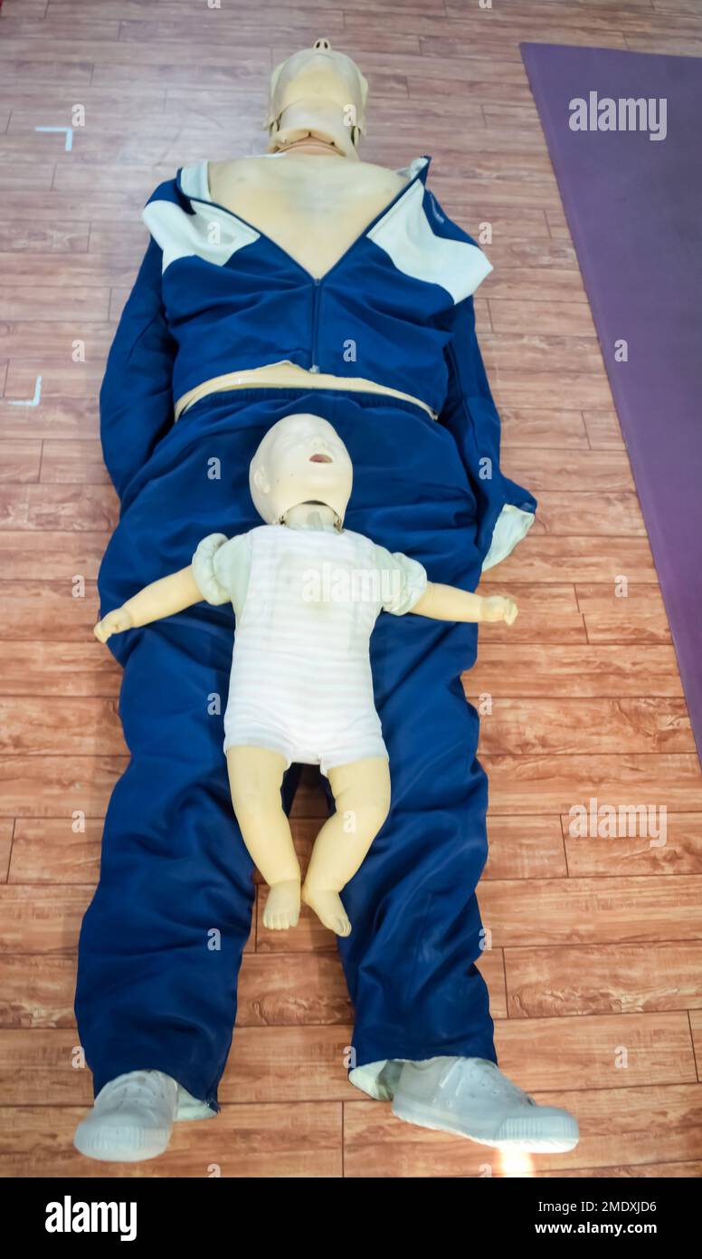 Human dummy lies on the floor during first Aid Training - Cardiopulmonary resuscitation. First aid course on CPR dummy, CPR First Aid Training Concept Stock Photo