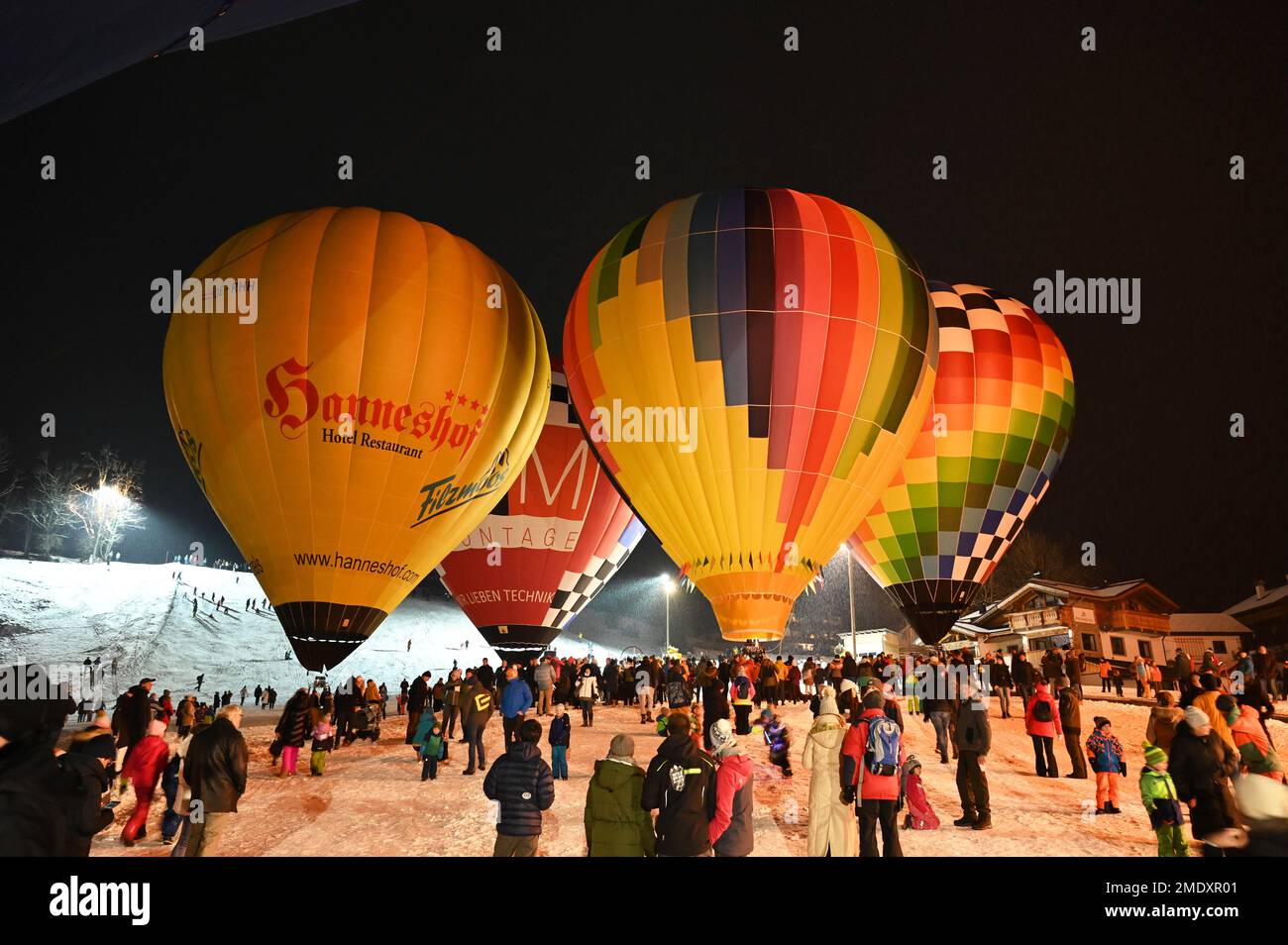 At the night of the balloons, the balloonists fire their balloons on the ground and create a colorful spectacle Stock Photo