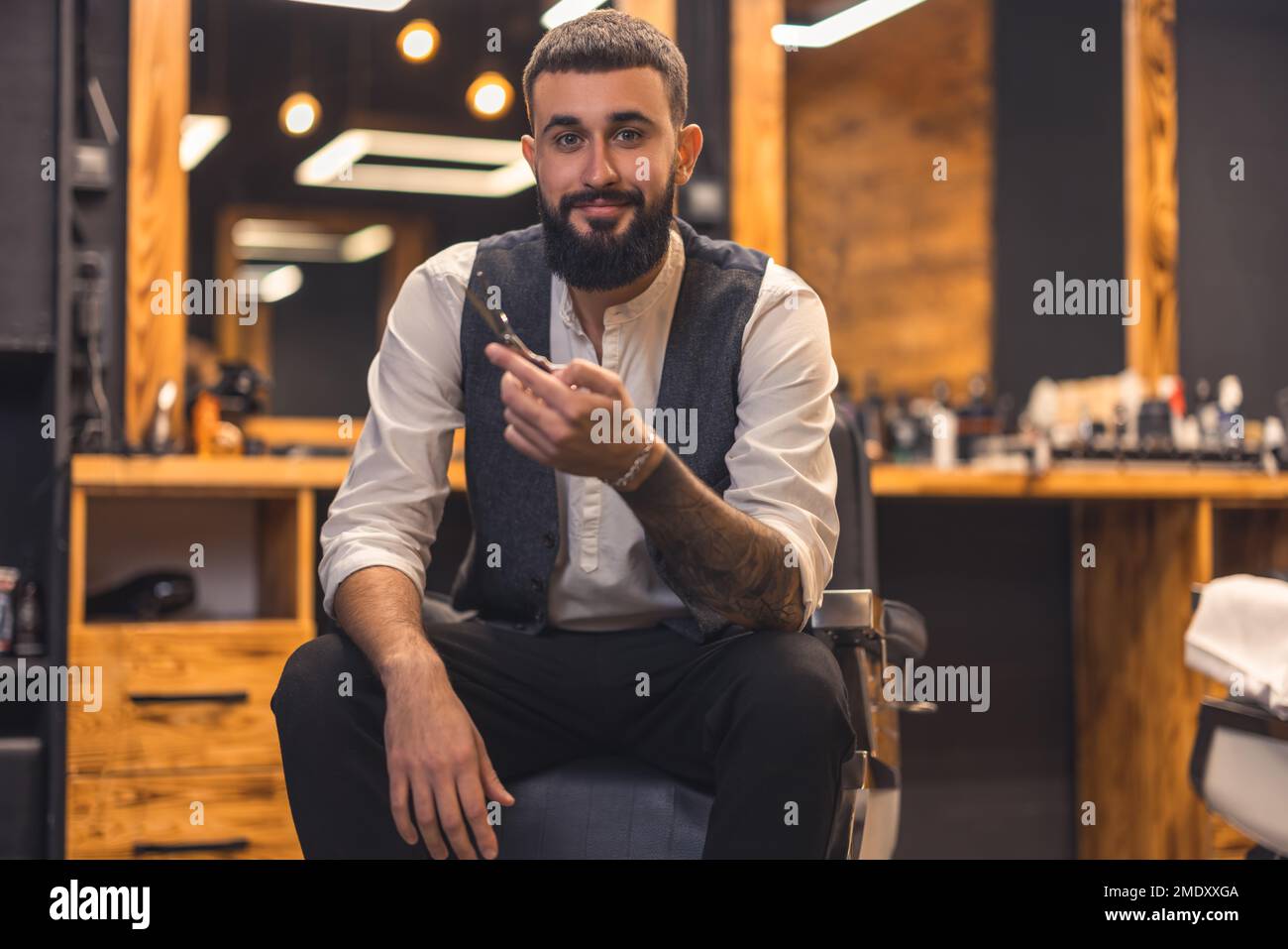 Handsome stylish barber at this working place Stock Photo