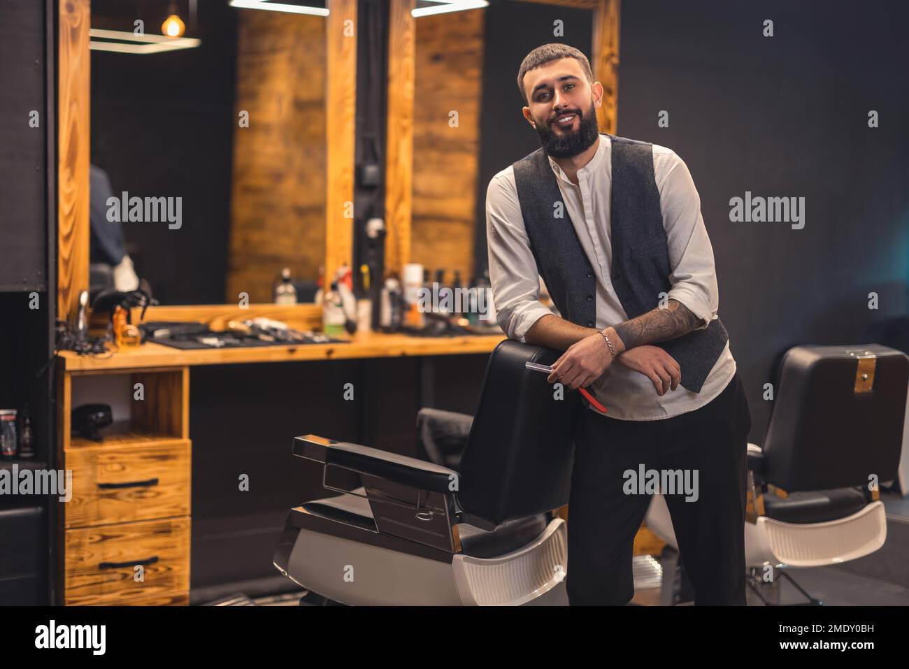 Dark-haired bearded man in a stylish outfit looking confident Stock Photo