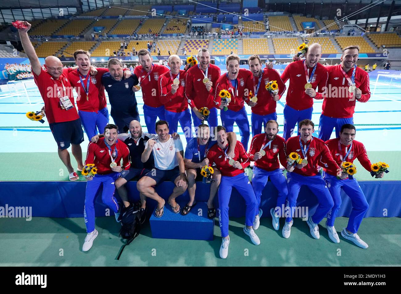 The Serbian men's water polo team poses with their gold medals after