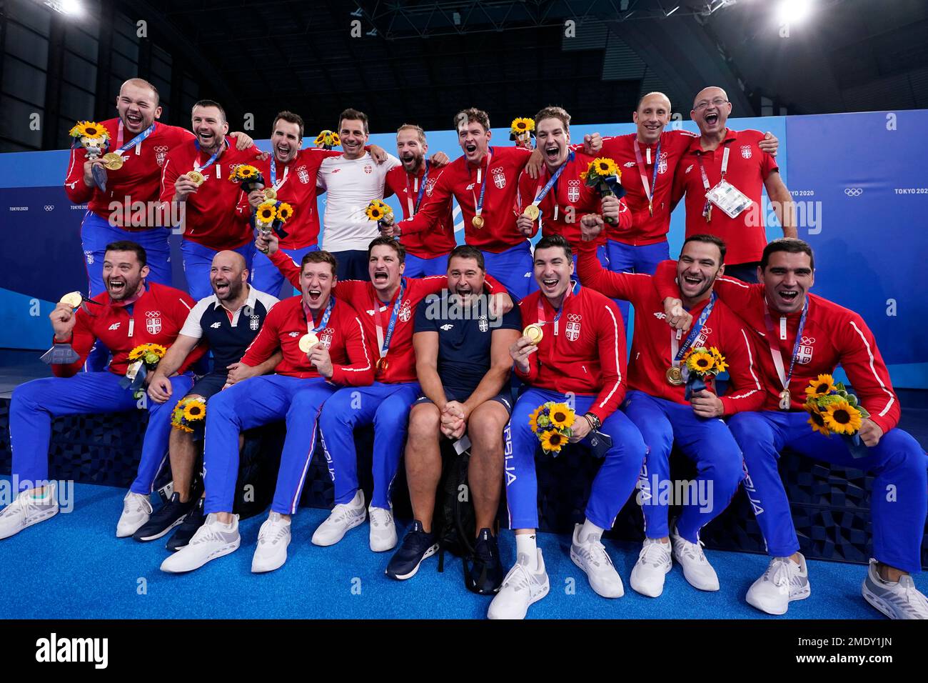 The Serbian men's water polo team poses with their gold medals after