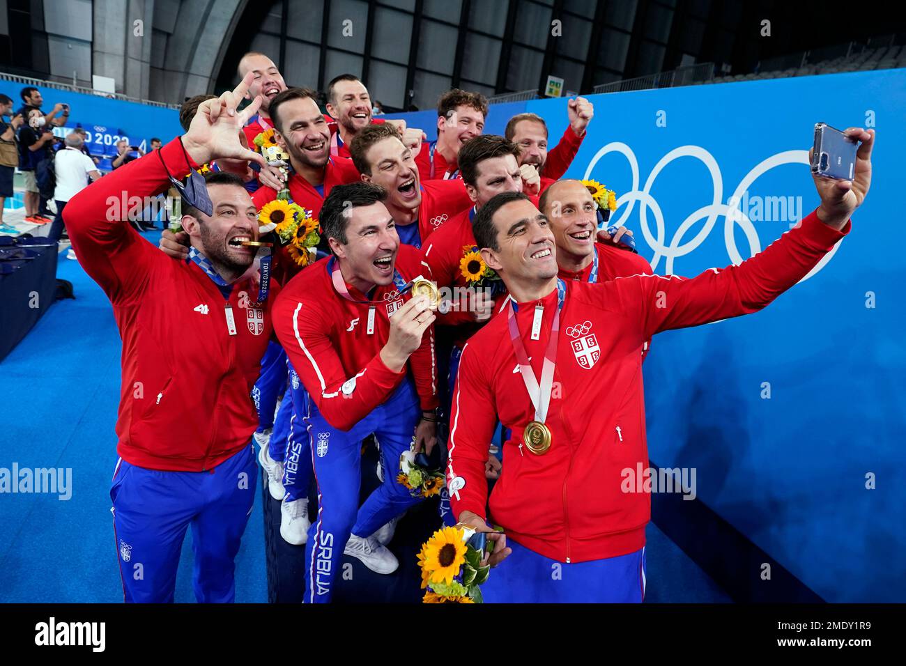 The Serbian men's water polo team poses for a picture with their gold