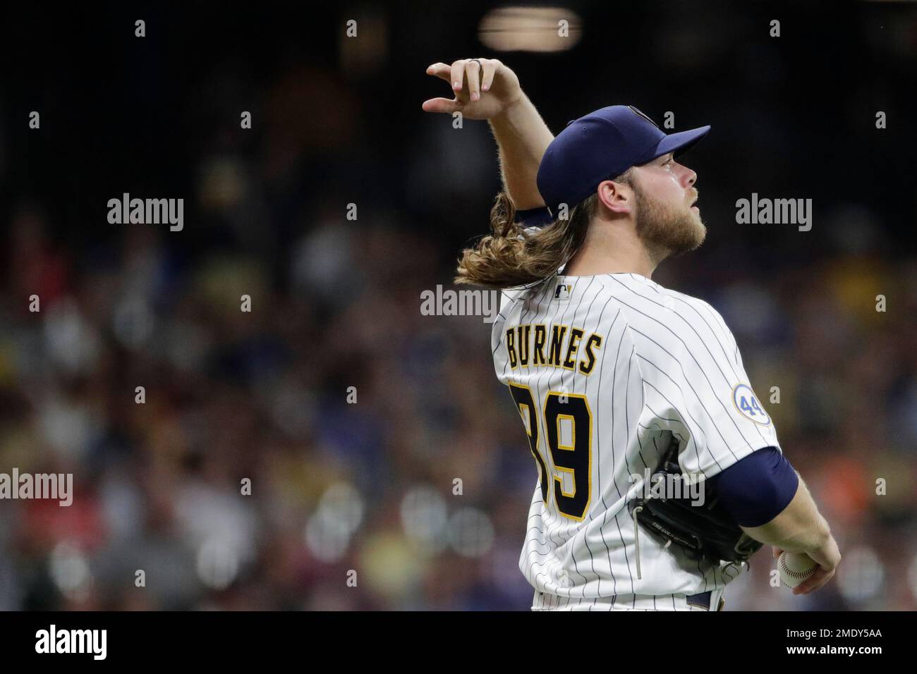 Milwaukee Brewers' Corbin Burnes adjusts his hair during the sixth inning  of a baseball game against the San Francisco Giants Friday, Aug. 6, 2021,  in Milwaukee. (AP Photo/Aaron Gash Stock Photo - Alamy