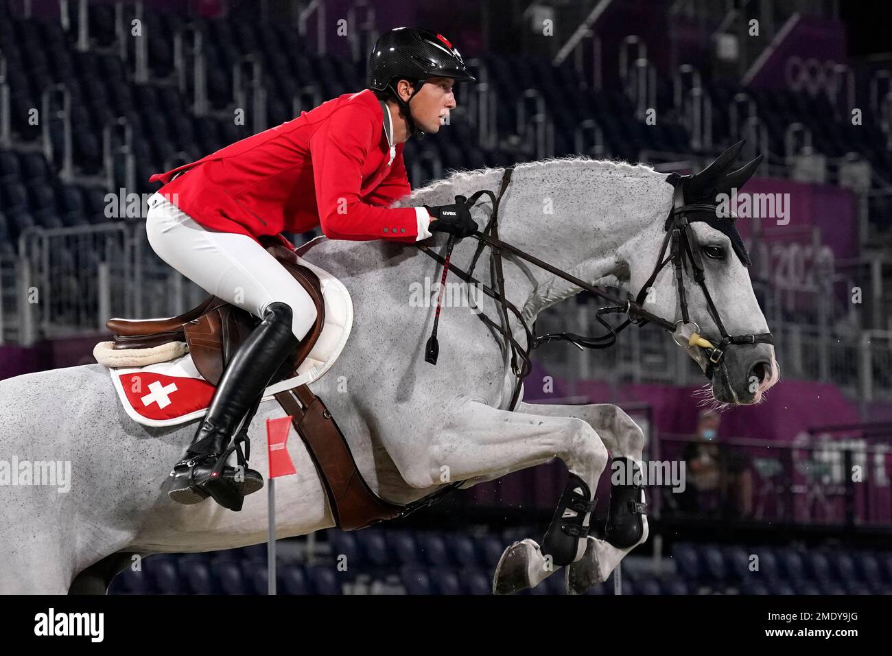Switzerlands Martin Fuchs, riding Clooney 51, competes during the equestrian jumping team final at Equestrian Park
