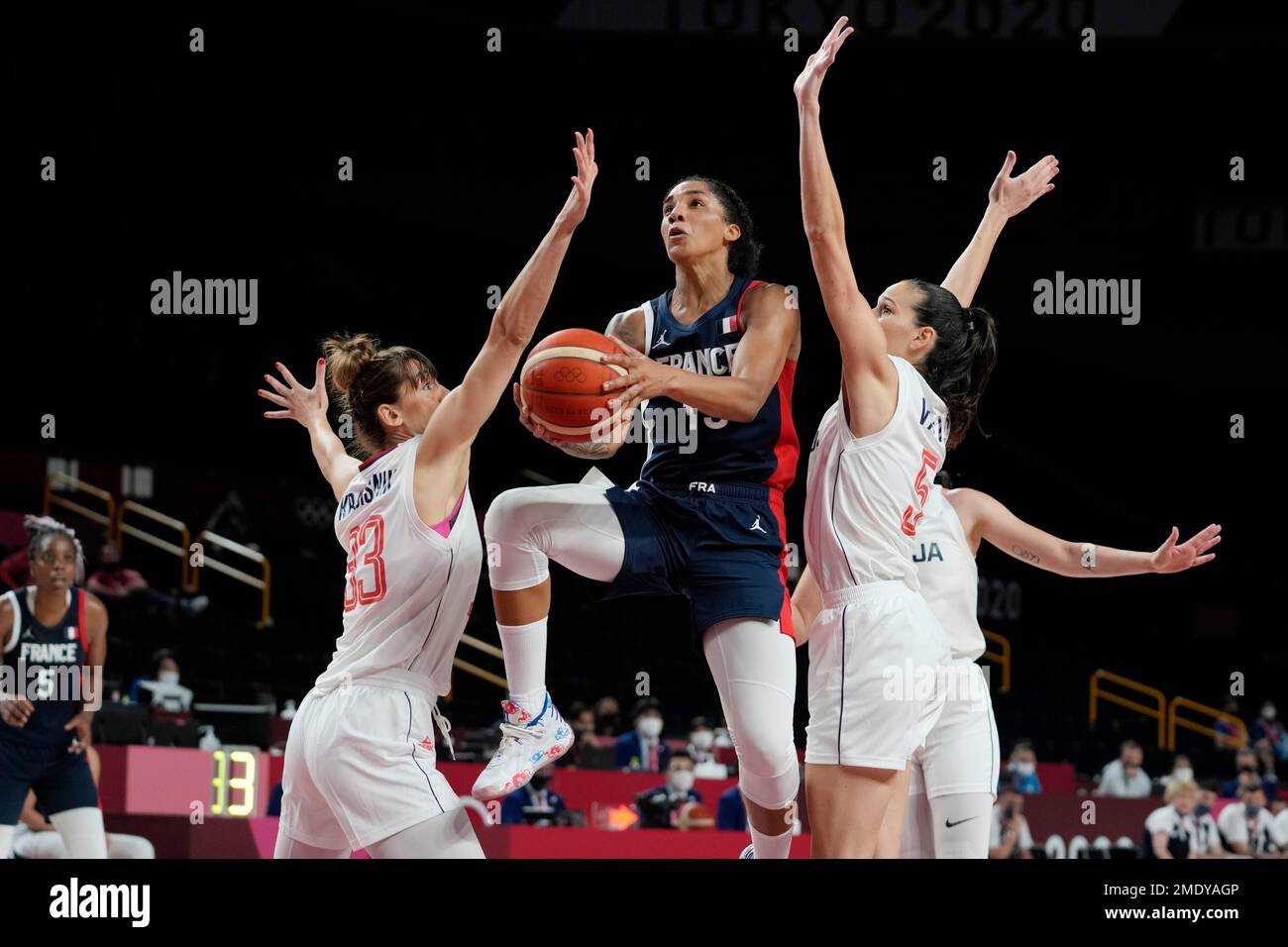 France's Gabrielle Williams drives to the basket ahead of Nigeria's Pallas  Kunaiyi-Akpanah, left, during a women's basketball preliminary round game  at the 2020 Summer Olympics, Friday, July 30, 2021, in Saitama, Japan. (