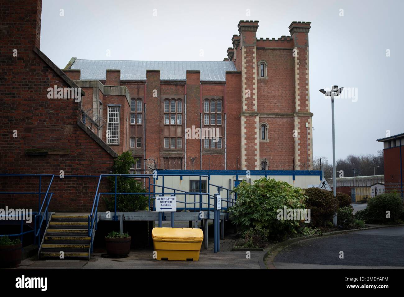An exterior view of buildings within the precincts of HMP Liverpool, also known as Walton Prison. The prison was given a scathing report in 2017 which pointed out various failings and problems. Present governor Pia Sinha was appointed in that year and in the next two years she turned the prison around with a programme of improvements and support for inmates and infrastructure. HMP Liverpool houses a maximum of 700 prisoners with an overall staff of around 250. Stock Photo