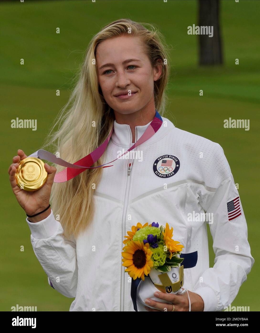 Nelly Korda, of the United States, poses with her gold medal, won in